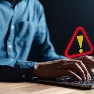 someone on a computer with a security alert